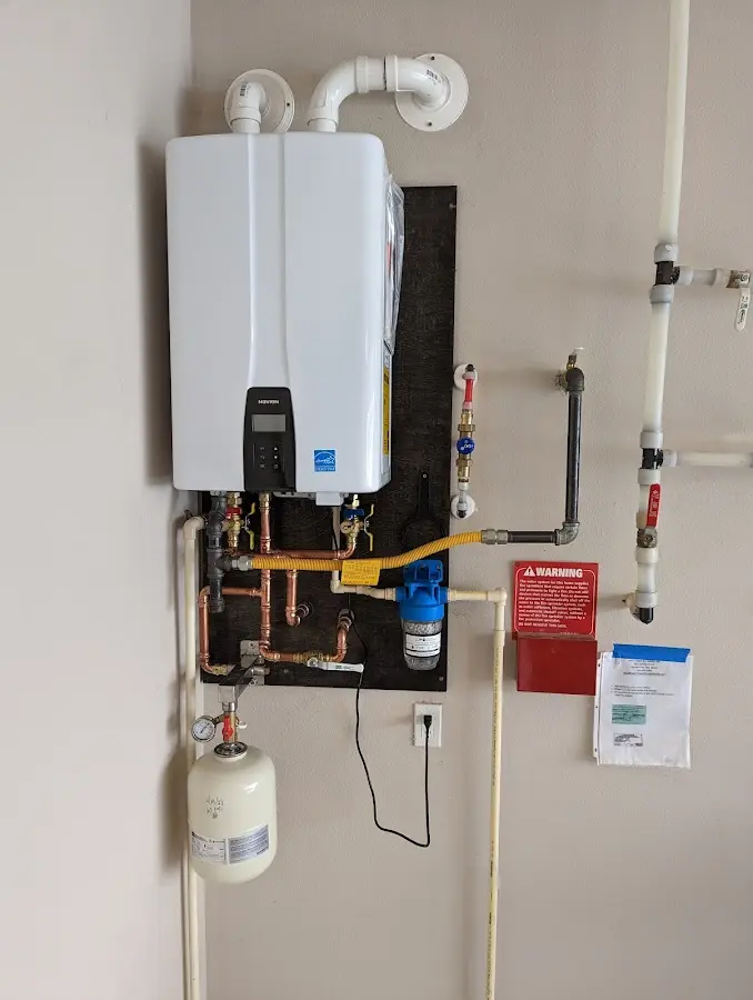 Professional plumber installing copper piping in a Welcome home